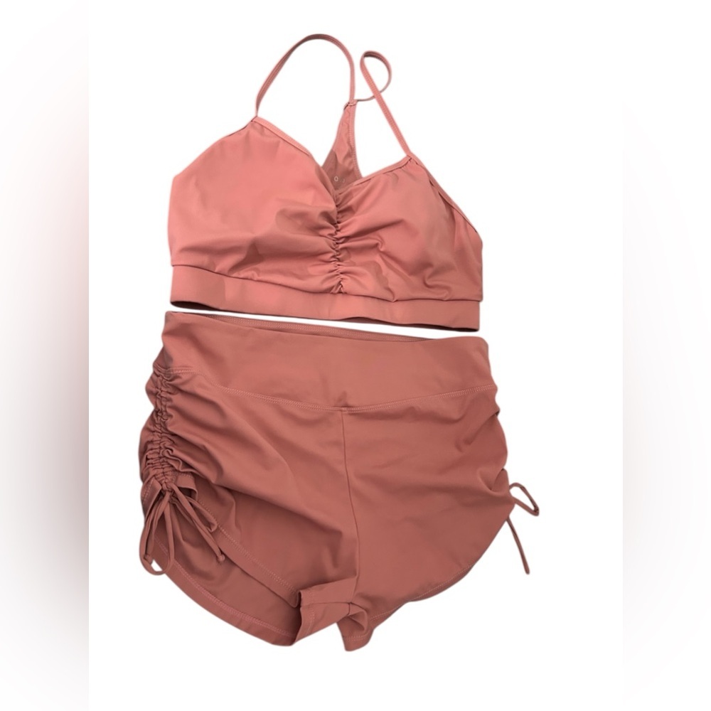 Pink ruched sports bra and shorts set activewear.